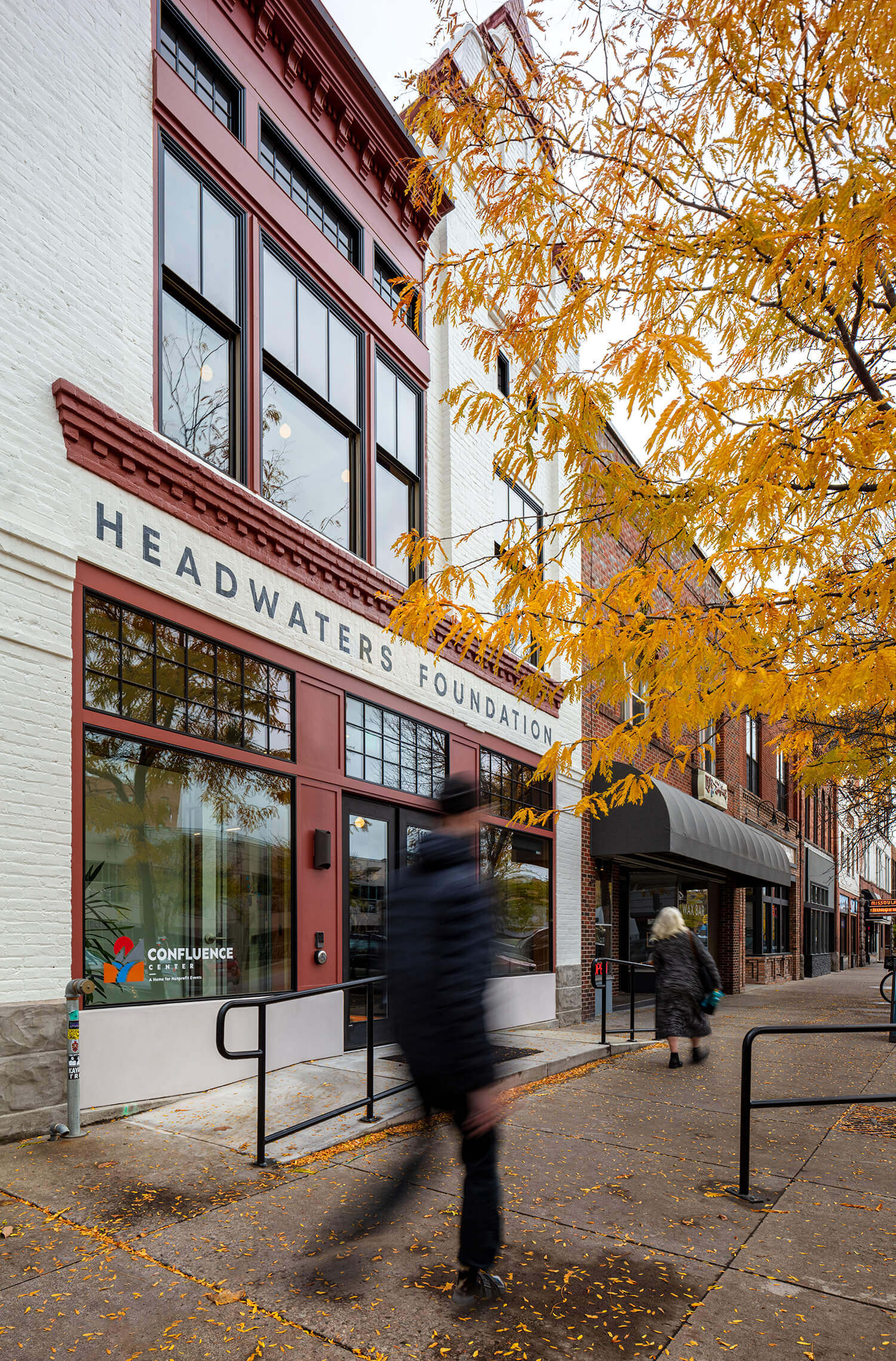 The front of the Headwaters Foundation building with the blur of someone walking by