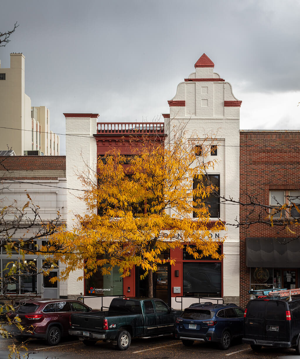 The Headwaters Foundation building in the fall with a yellow tree in front of it.