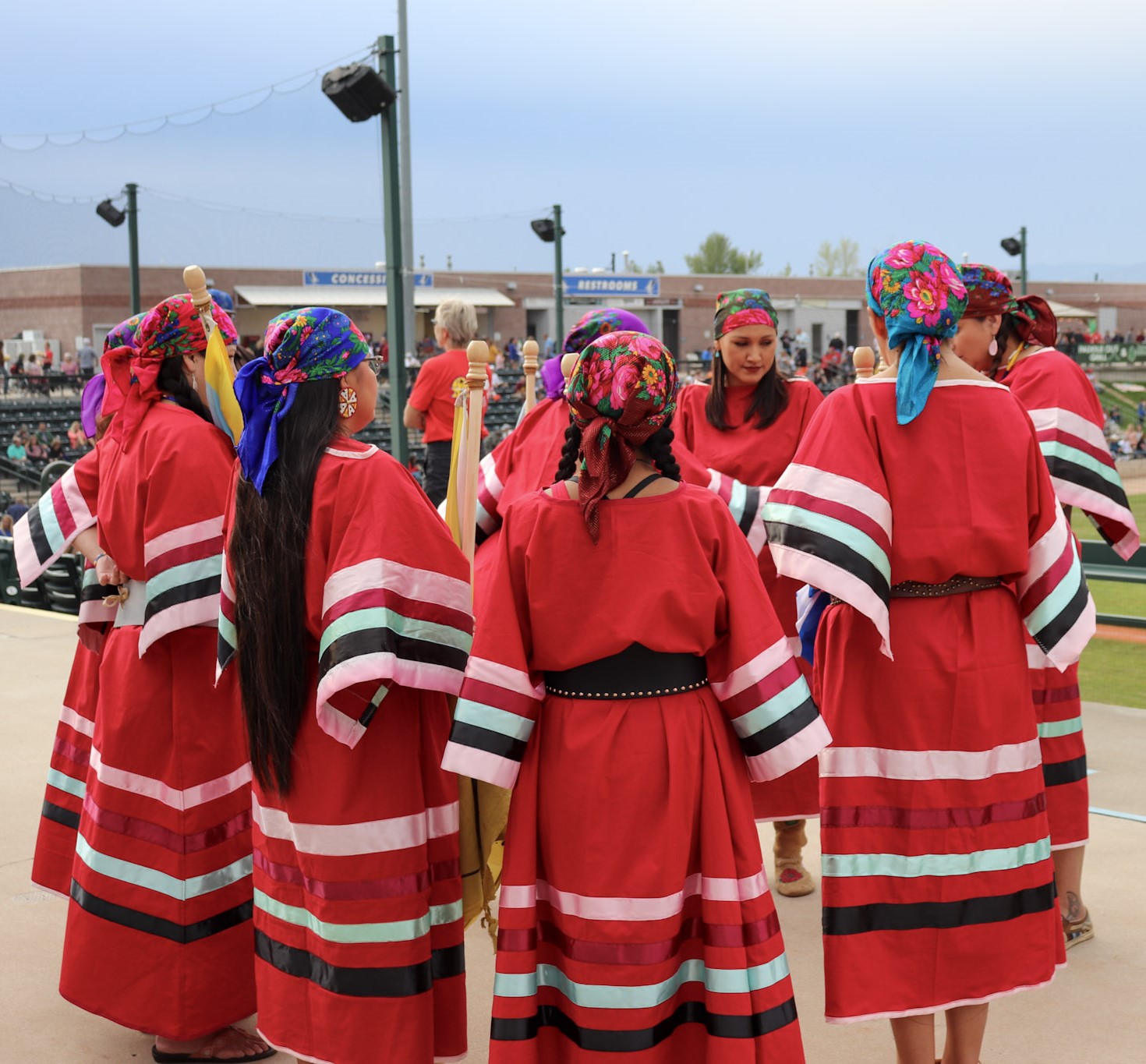 Native women prepare to perform at baseball game