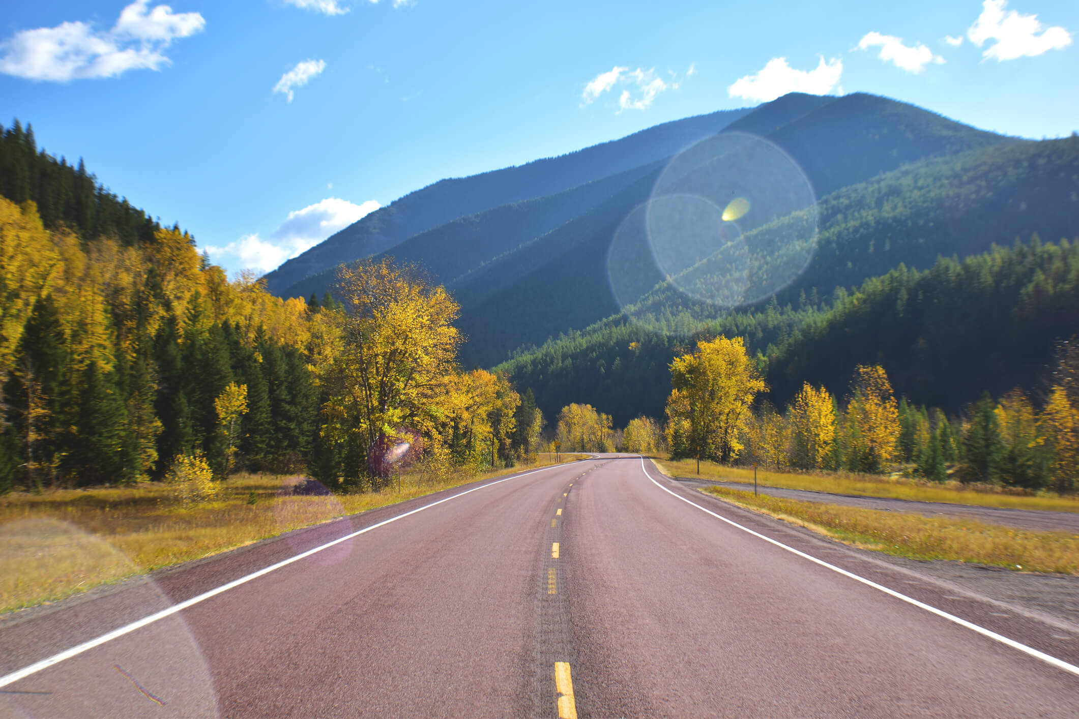 Montana road going into the mountains to symbolize Headwater's history here