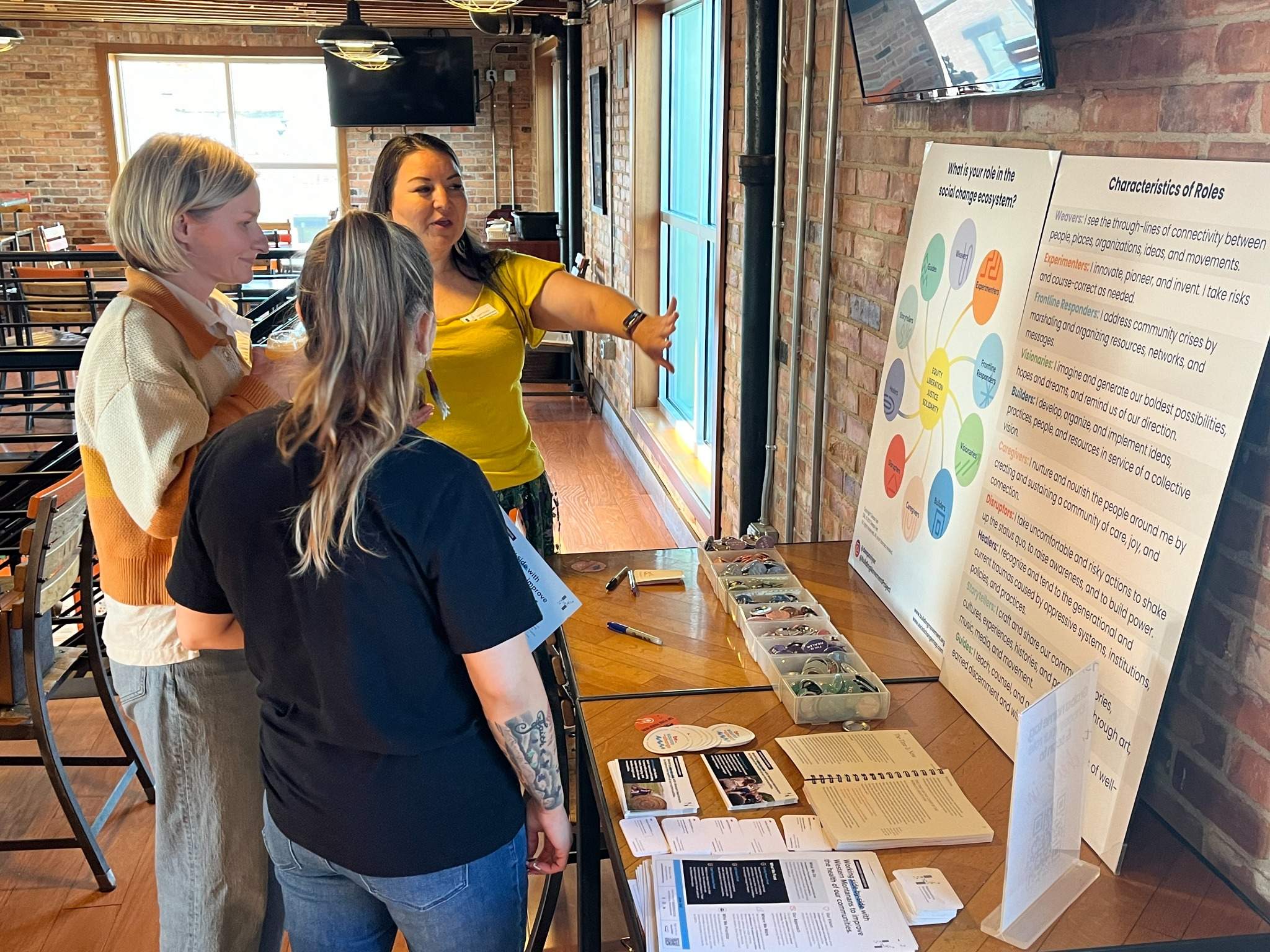 People stand at a table and talk